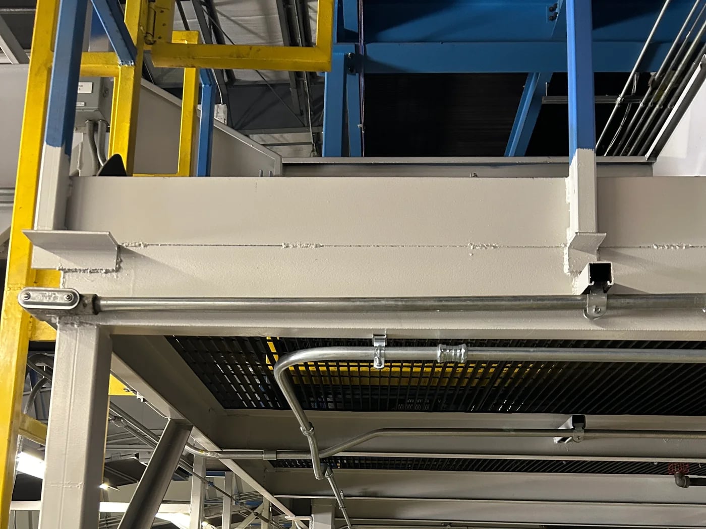 Commercial EMT conduit routed across an industrial steel structure