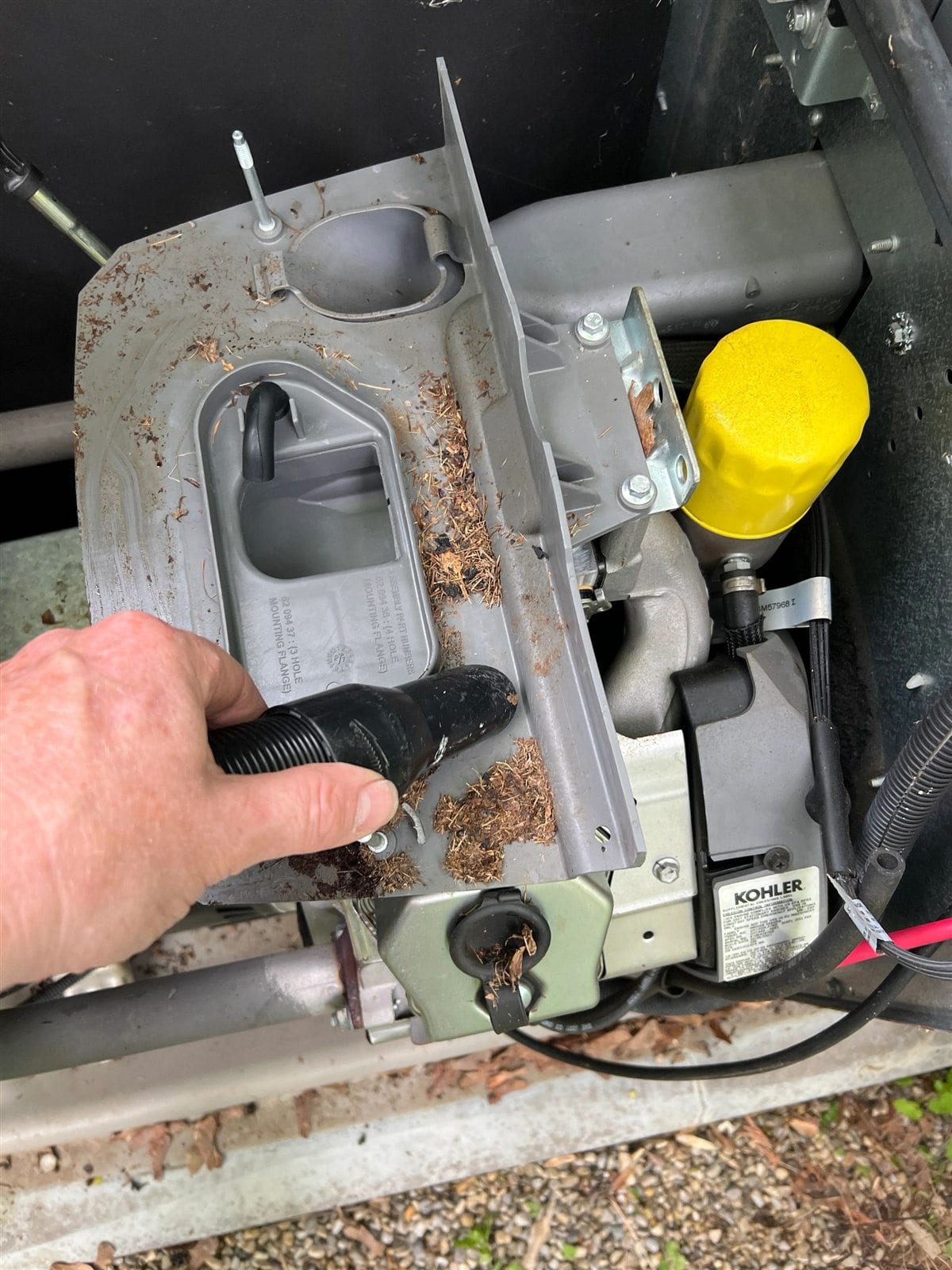 Buckeye Electric technician cleaning debris from a standby generator